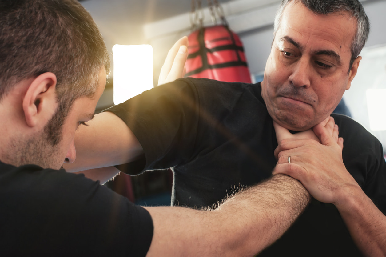 two men assaulting each other by choking and shoving